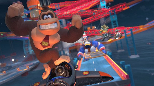 Donkey Kong jumping out of flying car and flexing for the camera in Mario Kart World