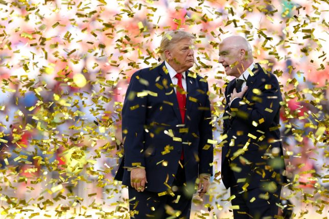 EAST RUTHERFORD, NEW JERSEY - JULY 19: U.S. President Donald Trump and FIFA President Gianni Infantino walk off the stage after presenting the FIFA World Cup Winner's Trophy to Spain during the FIFA World Cup 2026 Final match between Spain and Argentina at New York New Jersey Stadium on July 19, 2026 in East Rutherford, New Jersey. (Photo by Alex Pantling - FIFA/FIFA via Getty Images)