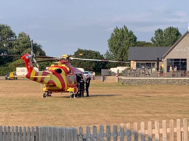 Emergency services on scene after an incident was declared on Mersea Island seafront. // A teenage girl and a woman in her 40s have died after three people got into difficulty in the sea. Emergency services raced to the scene at West Mersea, Essex, at around 5.35pm on Wednesday (July 22) after the alarm was raised by the ambulance service. Despite the efforts by rescuers, the teenage girl and the woman died at the scene. A third person remains in hospital in a serious condition. Photo released 23/07/2026