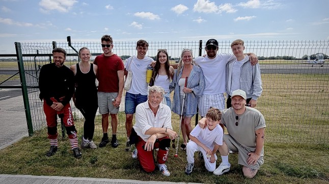The Cure Usher Wing Walkers and family posing for a group photo outside the airport.