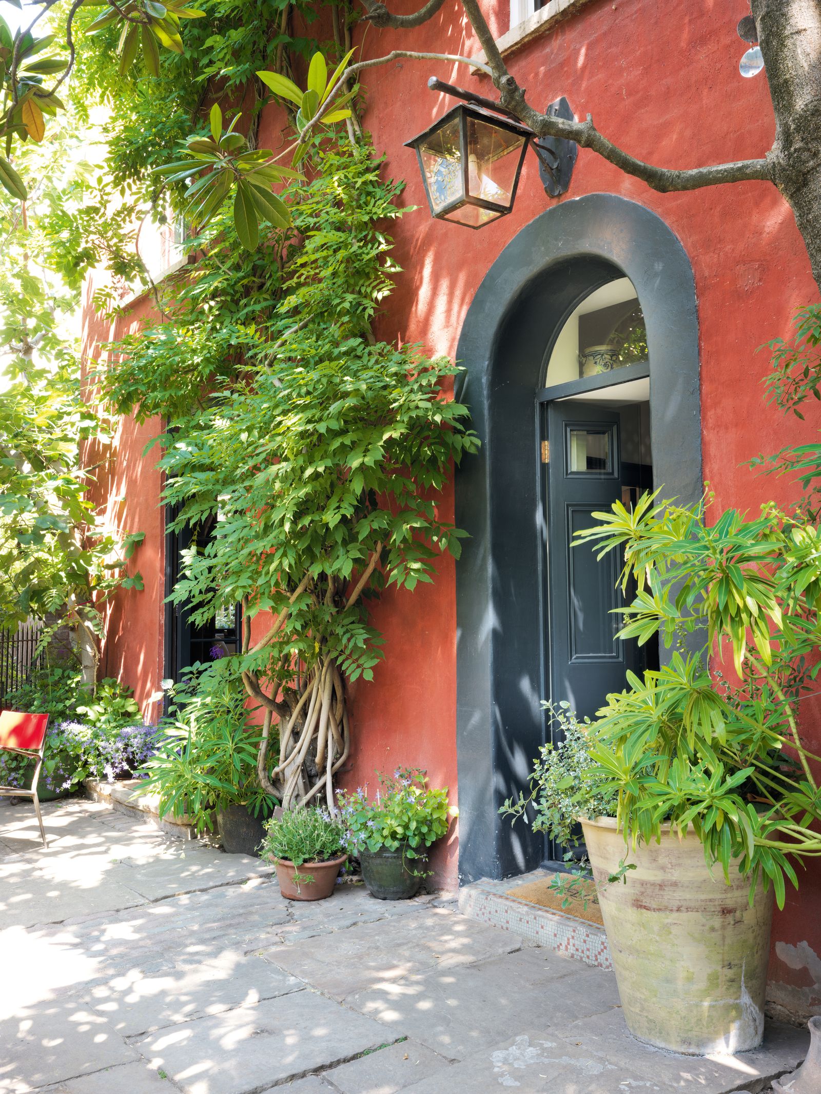 Image may contain Plant Potted Plant Architecture Building House Housing Villa Jar Planter Pottery Vase and Path