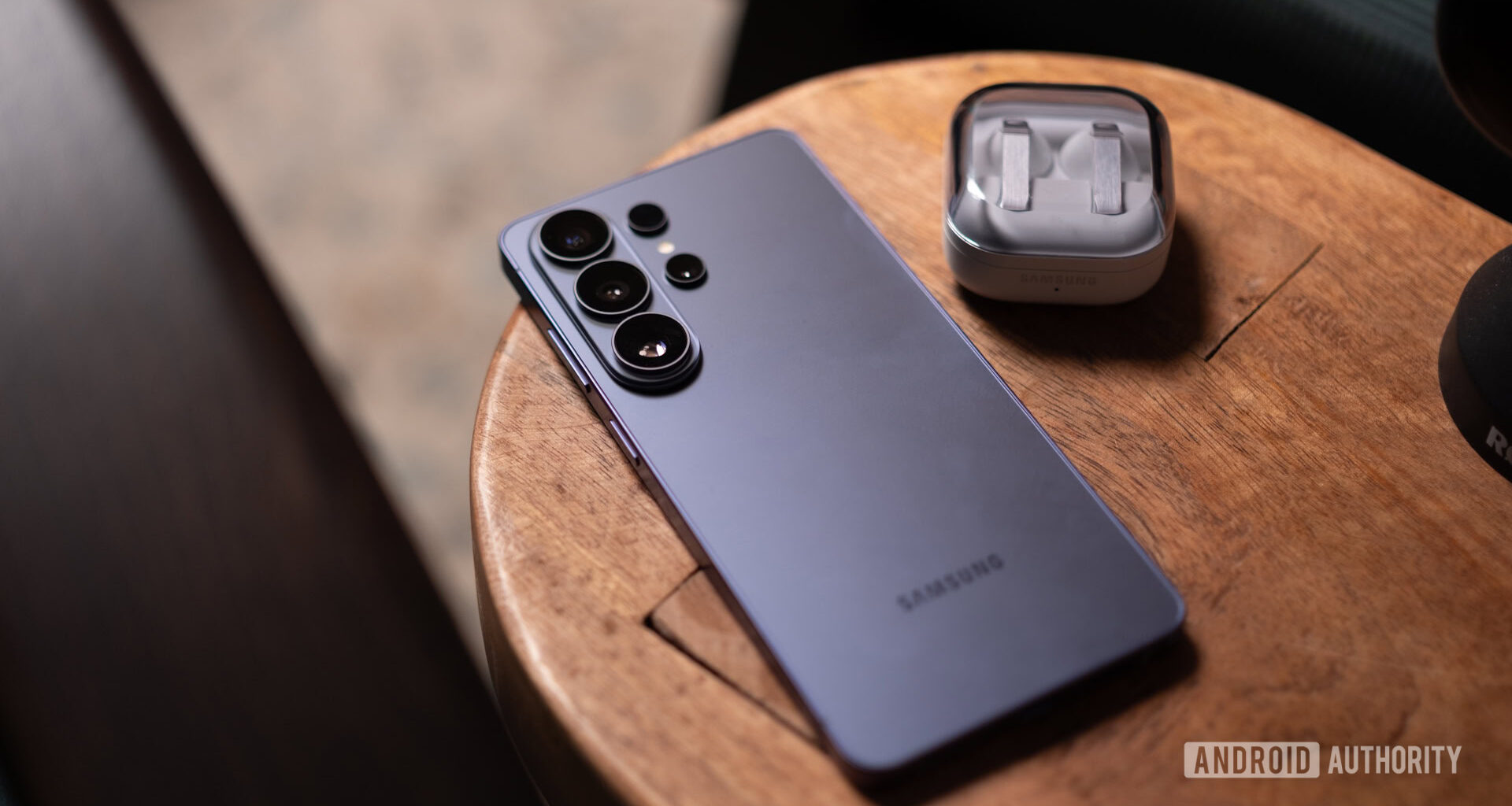 Samsung Galaxy S26 Ultra on table with earbuds