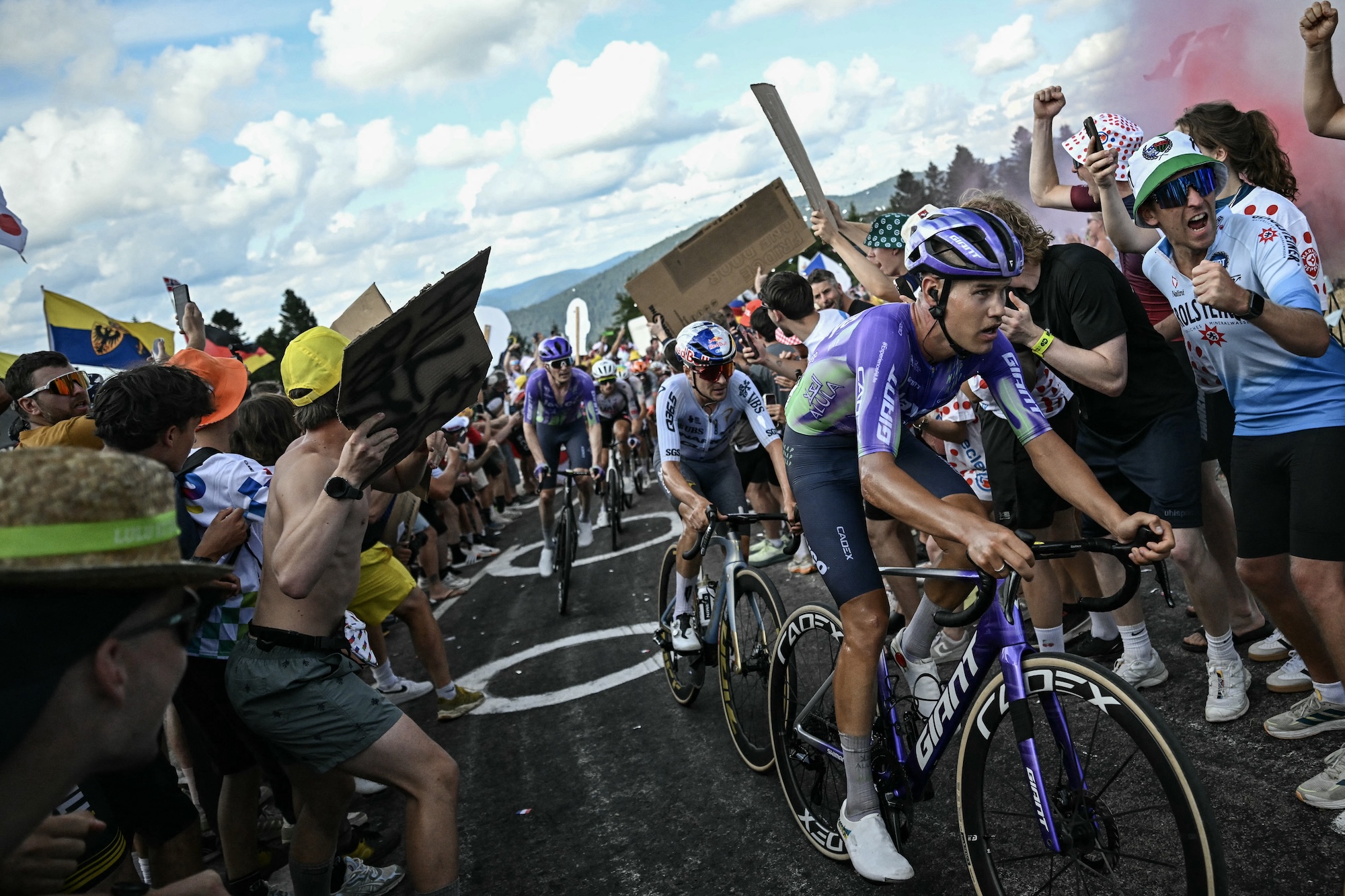 Team Jayco AlUla team's Australian rider Luke Plapp (R), Pinarello Q36.5 Pro Cycling Team's British rider Tom Pidcock (C) and Team Jayco AlUla's Swiss rider Mauro Schmid cycle in the Ballon d'Alsace ascent during the 13th stage of the 113th edition of the Tour de France cycling race, 205,8 km between Dole and Belfort in eastern France, on July 17, 2026. (Photo by Loic VENANCE / AFP)