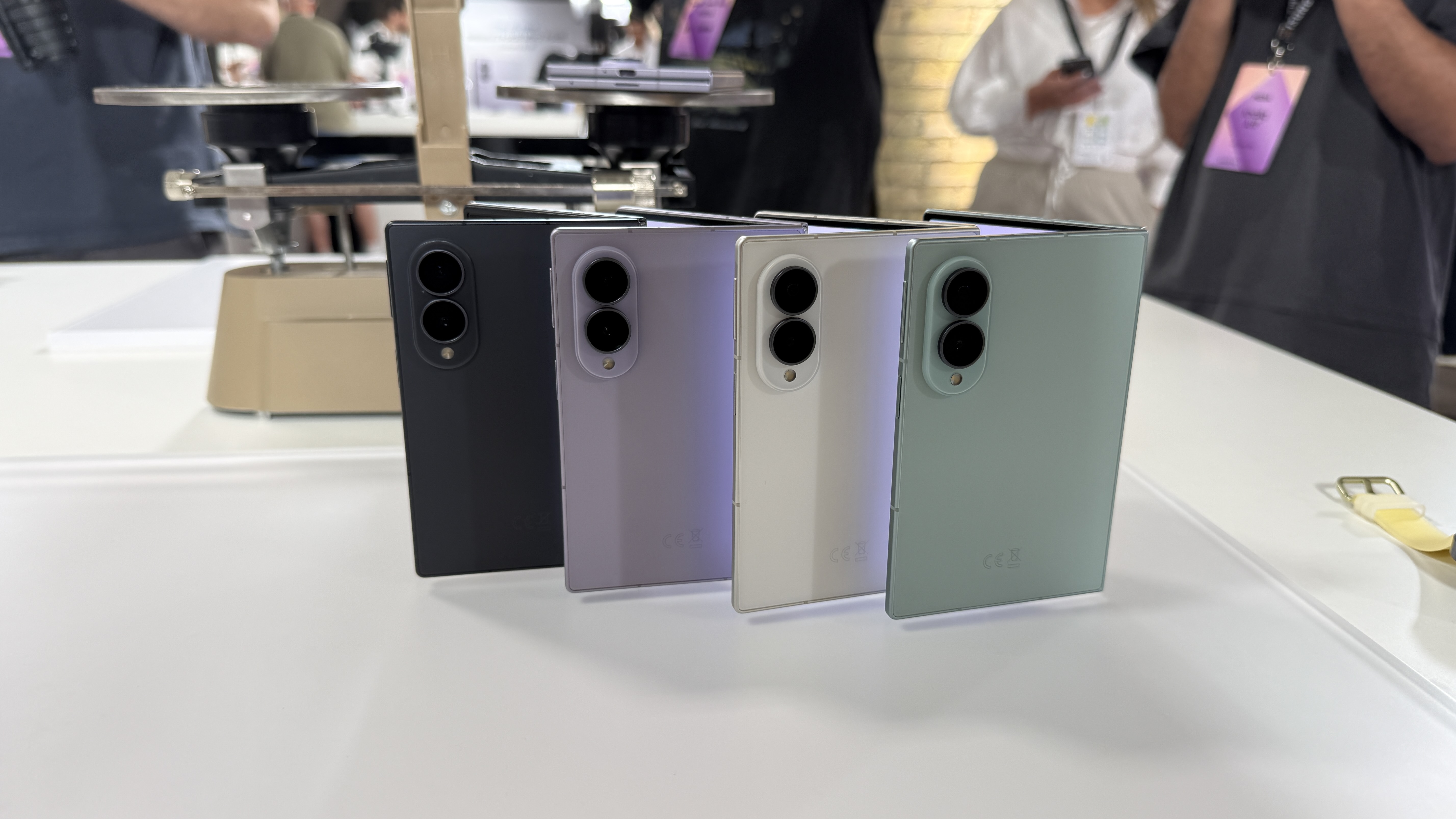 Samsung Galaxy Z Fold 8 and 8 Ultra in hand at a hands on event with a brick wall in the background