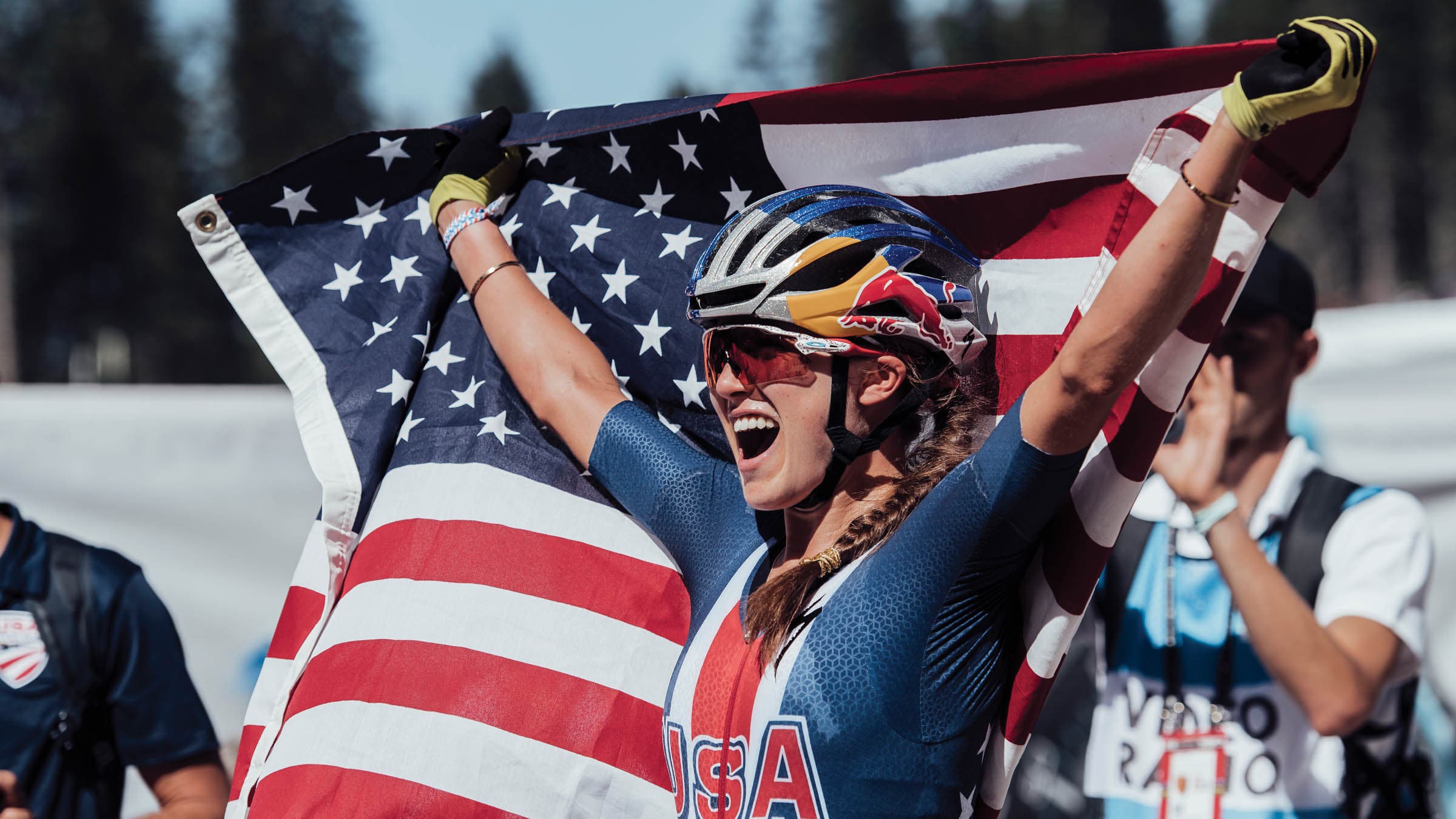 Kate Courtney holding an American flag
