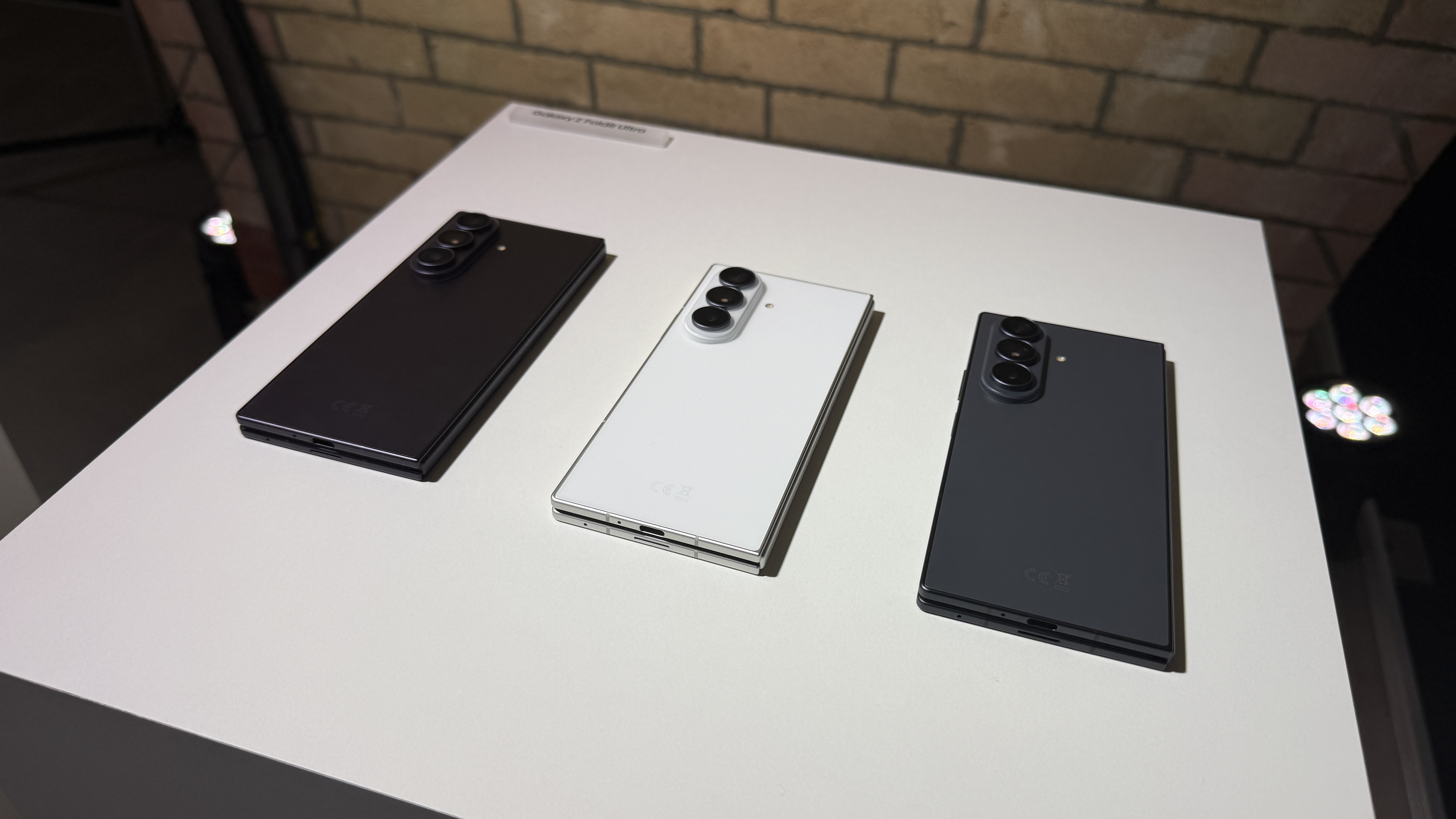 Samsung Galaxy Z Fold 8 Ultra on a white tablet with a brick background