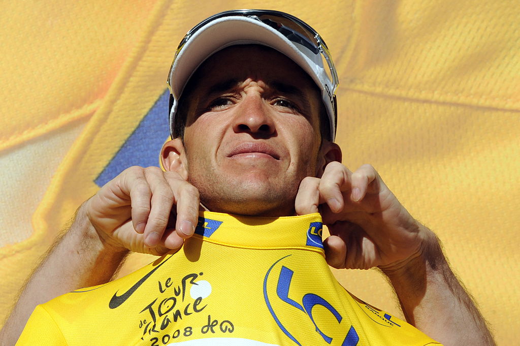 Close up of Carlos Sastre being dressed in the yellow jersey