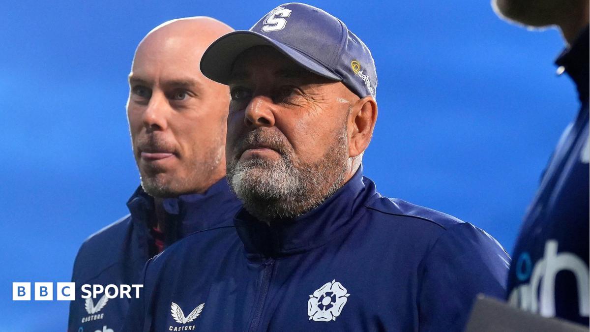 Darren Lehmann, wearing a blue jacket with Northamptonshire's club badge on and a blue hat with the S logo to represent the Steelbacks nickname.