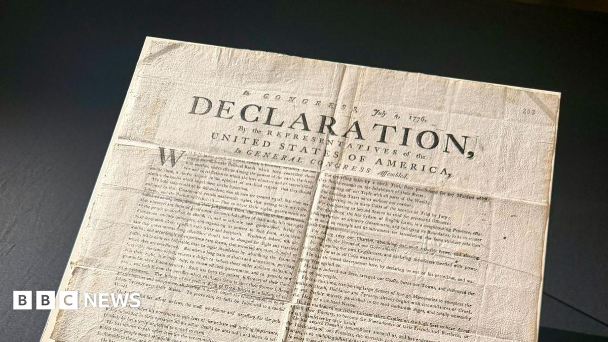 A copy of the US Declaration of Independence. The word "declaration" can be seen in capital letters on the document, which has various folds and creases.