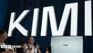 Visitors at a trade show in Shanghai visit a booth with the Kimi sign displayed in large block letters