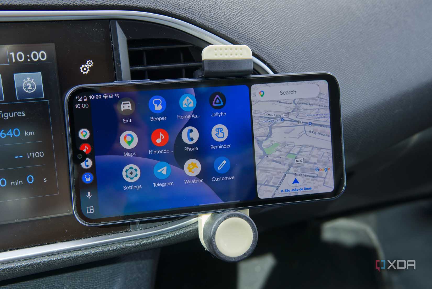 An Android phone displaying the Android Auto interface with an app list next to Google Maps