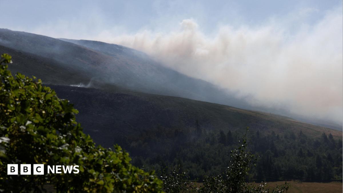 Smoke from a moorland blaze rises near the Dovestone Reservoir.