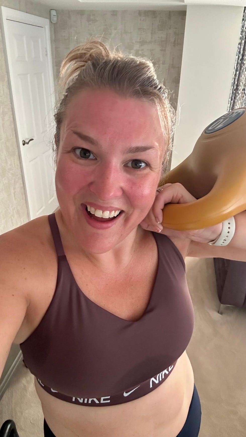 sara davies fitness routine: sara smiling holding a kettlebell