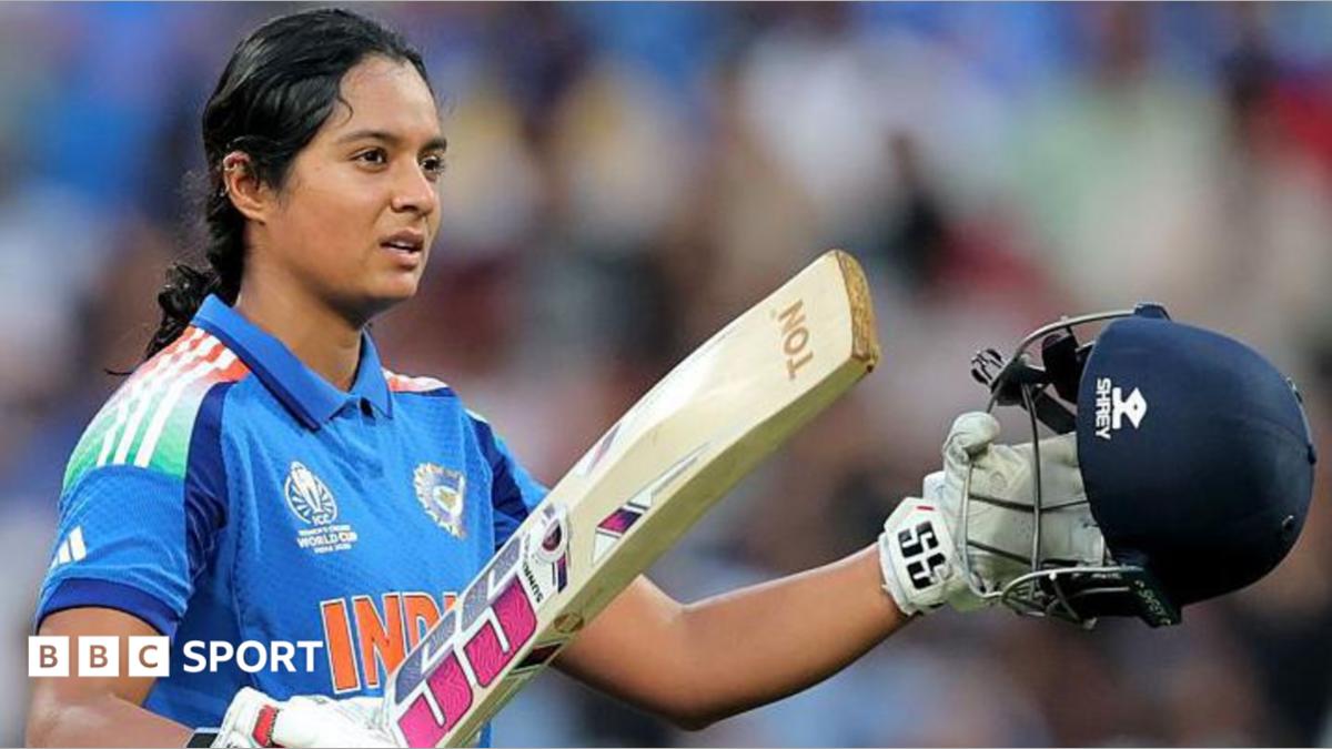 Pratika Rawal celebrates scoring a century in a One-Day international for India. She is holding up her helmet in her left hand and bat in her right. She is wearing a blue India shirt