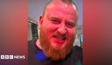 Shane Cullen, with an ginger beard and close-cropped hair, smiles for the camera