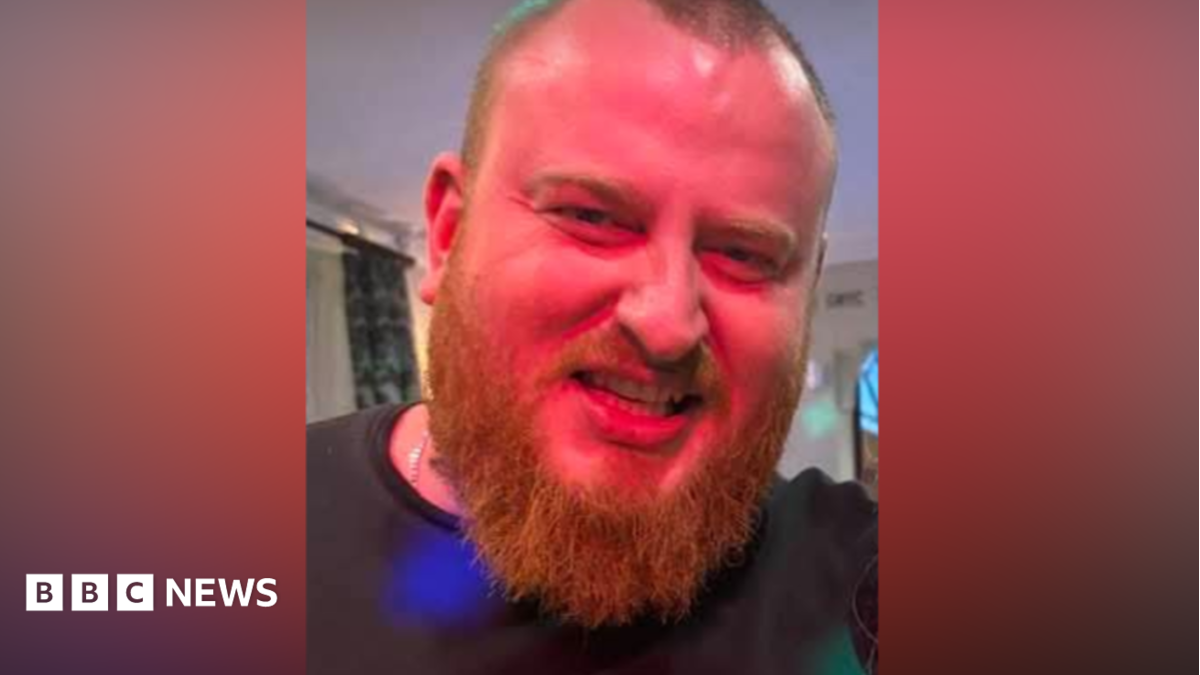 Shane Cullen, with an ginger beard and close-cropped hair, smiles for the camera