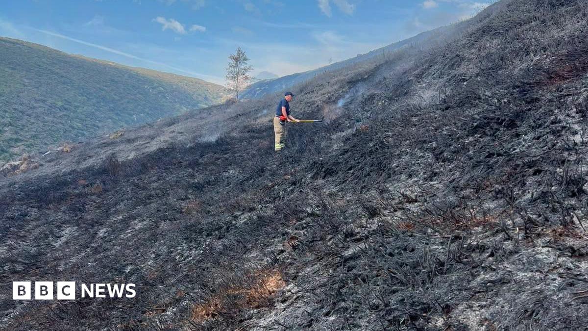 A large fire is seen on a mountainside