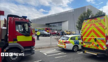 Police fire and ambulance service vehicles parked outside