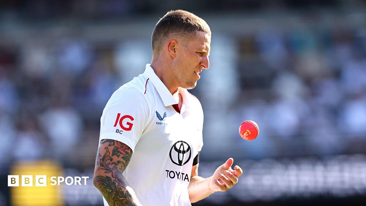 Brydon Carse playing for England in the day-night Test in Brisbane, during the day session as he throws up the pink ball