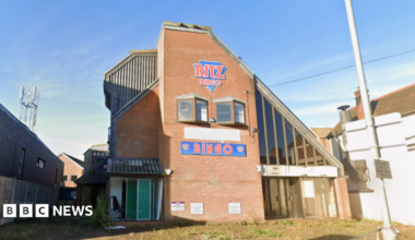 A derelict Bingo hall called 'Ritz Bingo' on a sunny day.