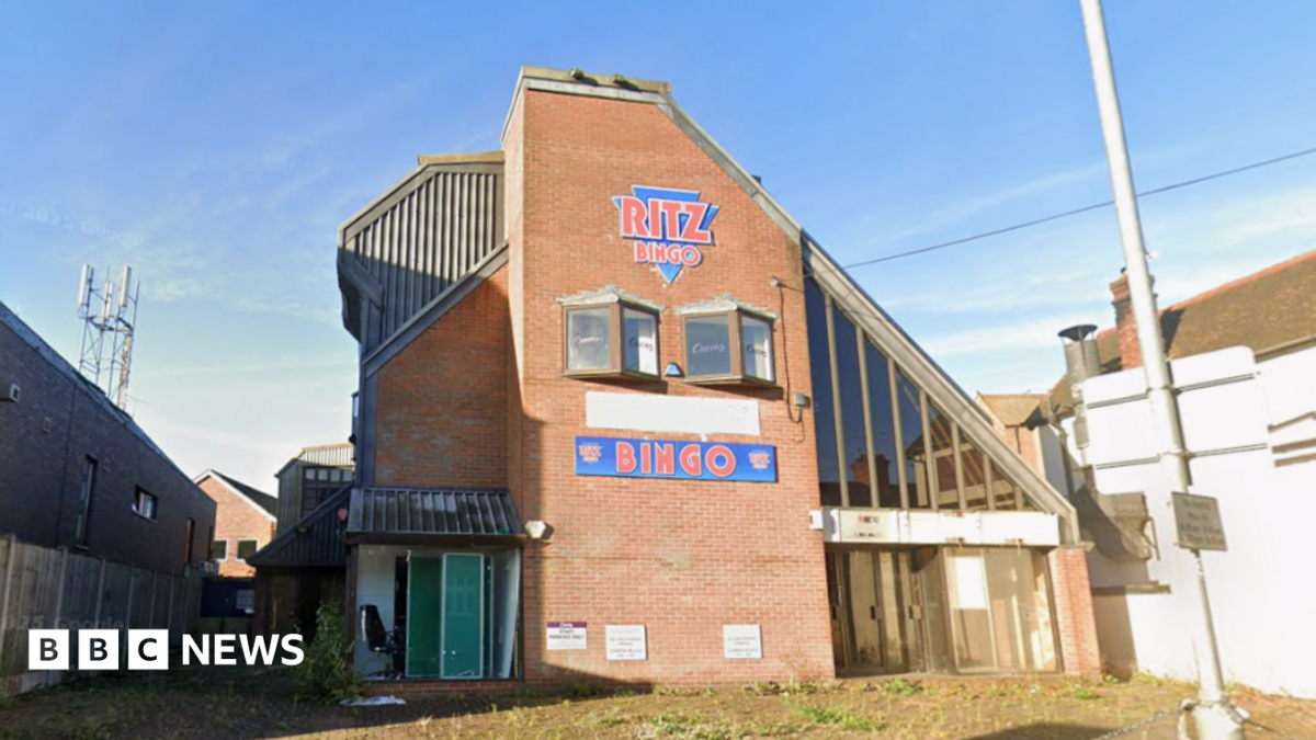 A derelict Bingo hall called 'Ritz Bingo' on a sunny day.