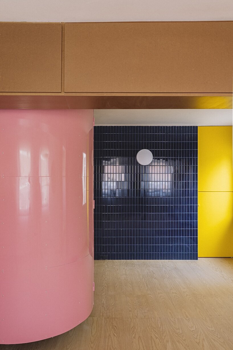 burr wraps madrid apartment in yellow storage walls with a suspended pink spiral staircase - 1