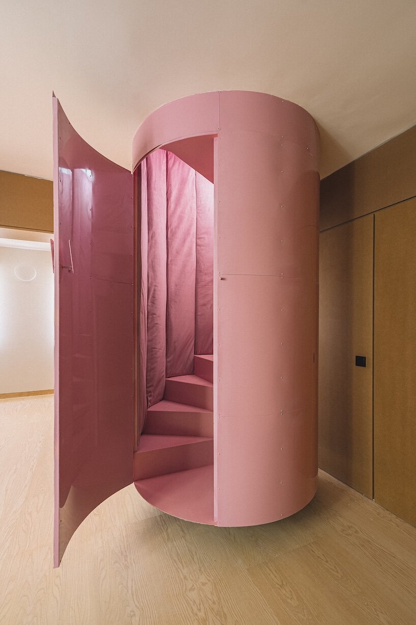 burr wraps madrid apartment in yellow storage walls with a suspended pink spiral staircase - 5