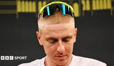 Tadej Pogacar looks downwards as he sports a close-cropped blond hairstyle