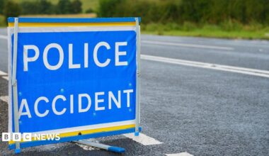A POLICE ACCIDENT sign by the side of a country road