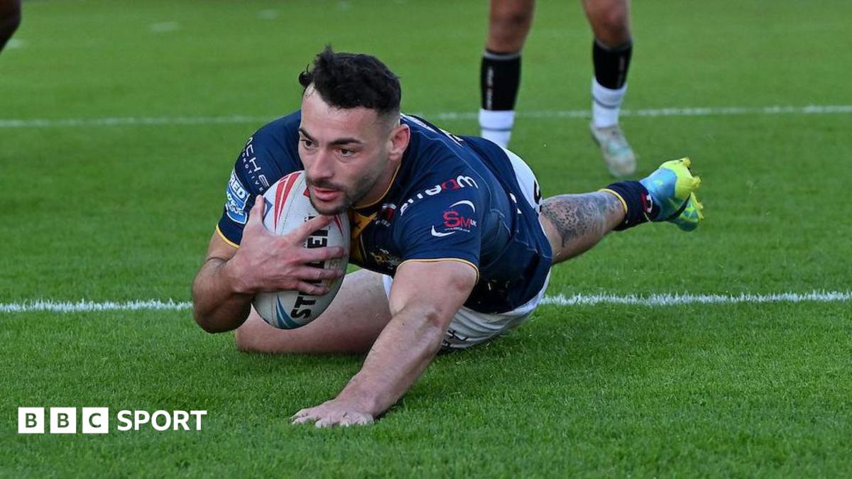 Jake Connor prepares to touch down for his first try as he slides over the line with ball tucked under his arm