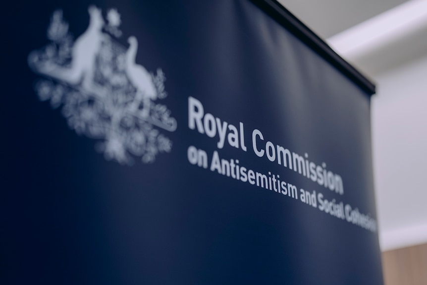 People walk into a building where police are present for the royal commission.