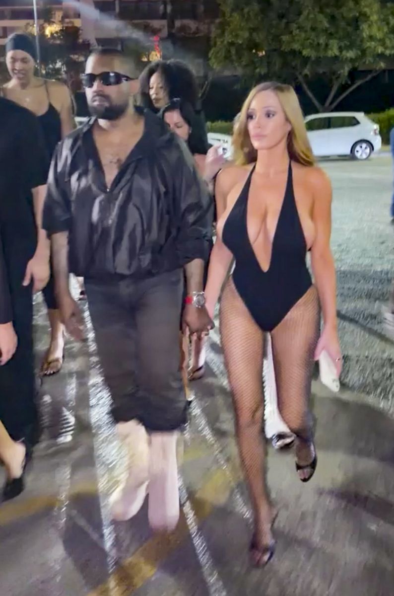 Bianca Censori completed the daring Ibiza look with sleek honey-blonde hair, understated glam makeup, black open-toe heels, and fishnet tights as she accompanied Kanye West for a night out.