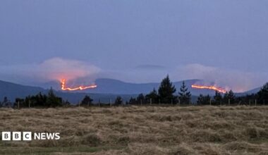 Stretch of mountains in the Cairngorms with wildfires burning across a large area