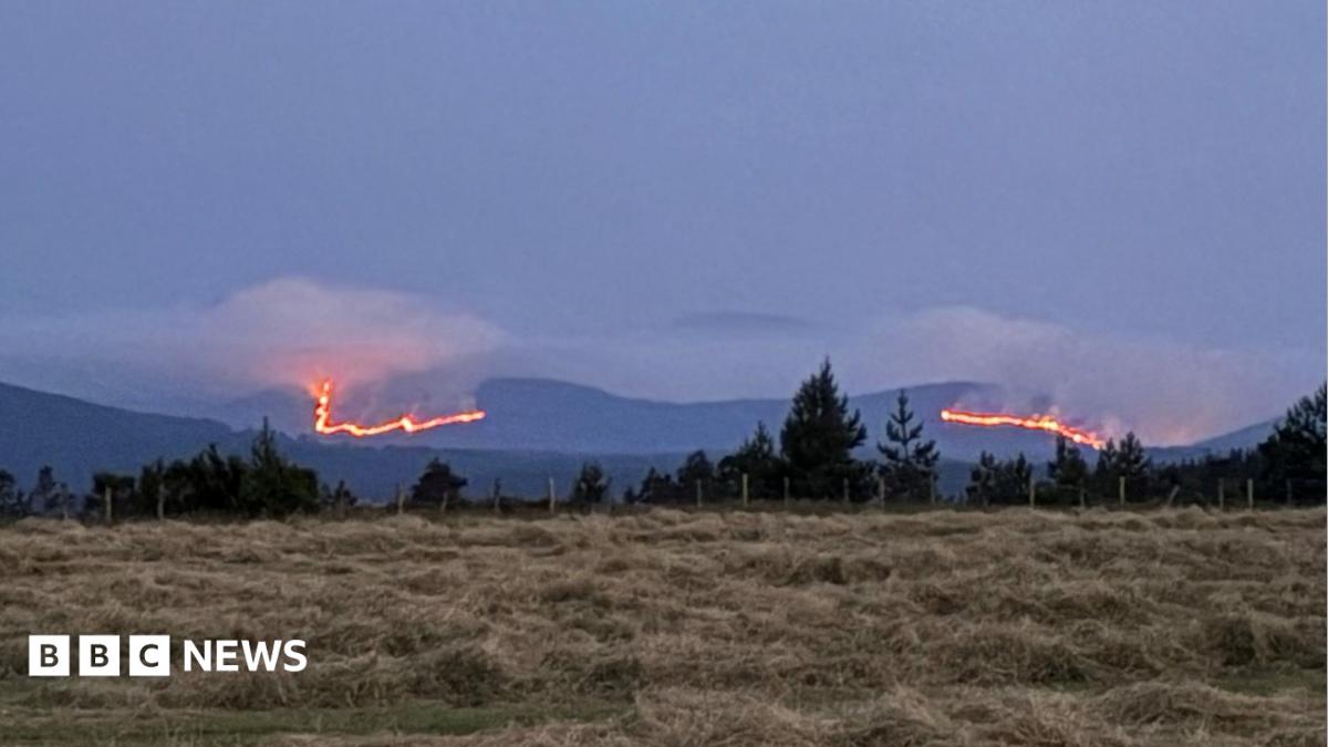 Stretch of mountains in the Cairngorms with wildfires burning across a large area