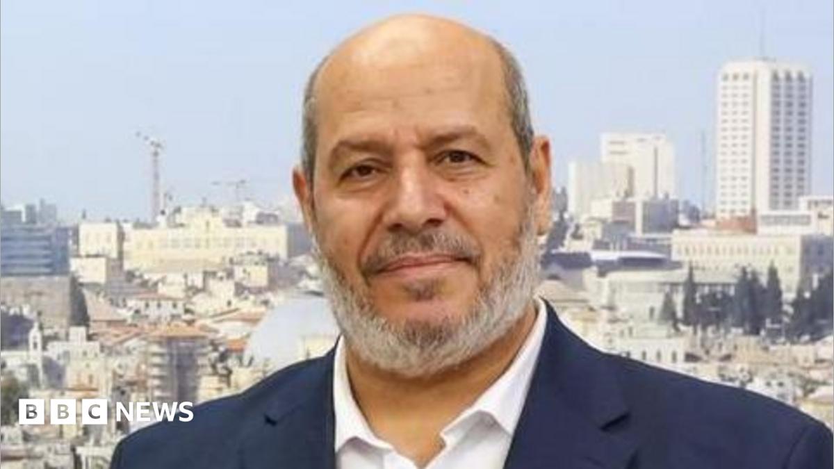 The image shows Donaghadee harbour with a white lighthouse in the background. In the foreground are a number of colourful boats.