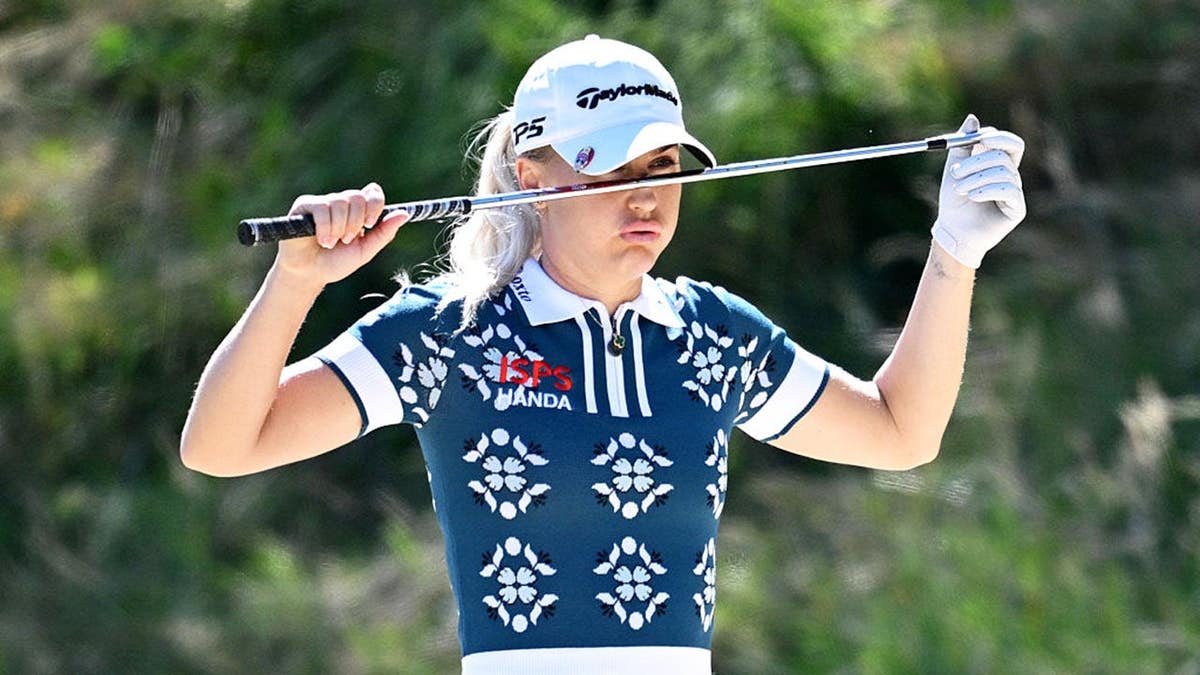 Charley Hull of England reacts as she prepares to play a shot on the third hole.