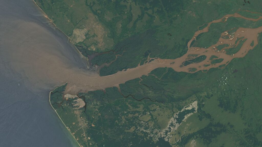 Aerial view of a river delta with waterways and green land.