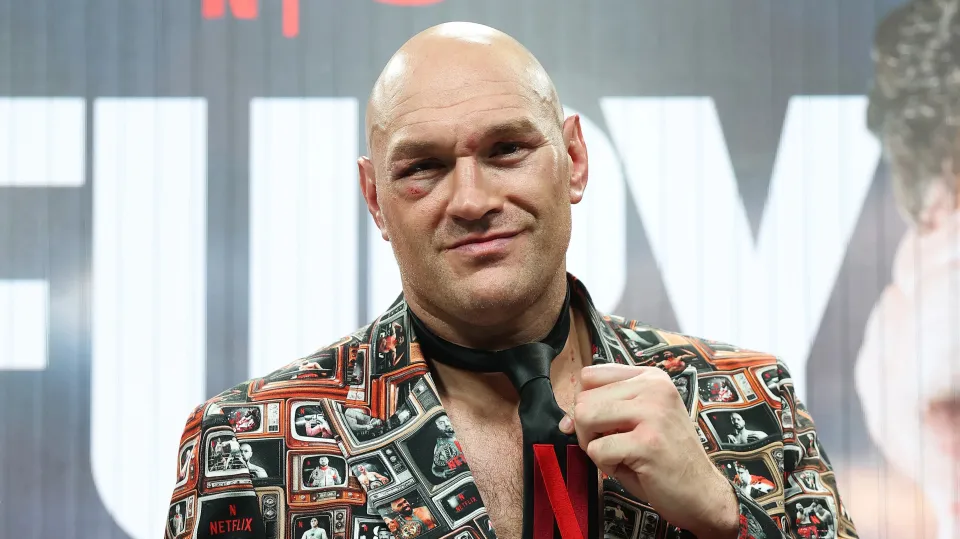 Tyson Fury points to the Netflix logo on his tie as he speaks to the media during a press conference after his victory in the Heavyweight fight between Tyson Fury and Arslanbek Makhmudov
