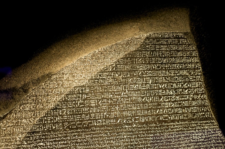 A replica of the Rosetta Stone showing the top portion of the stone with ancient Hieroglyphs followed by Demotic script.