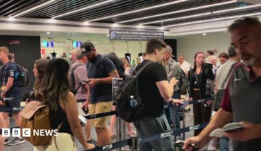People move through the queue for the Entry Exit System process at Fuimicino Airport in Rome, Italy.