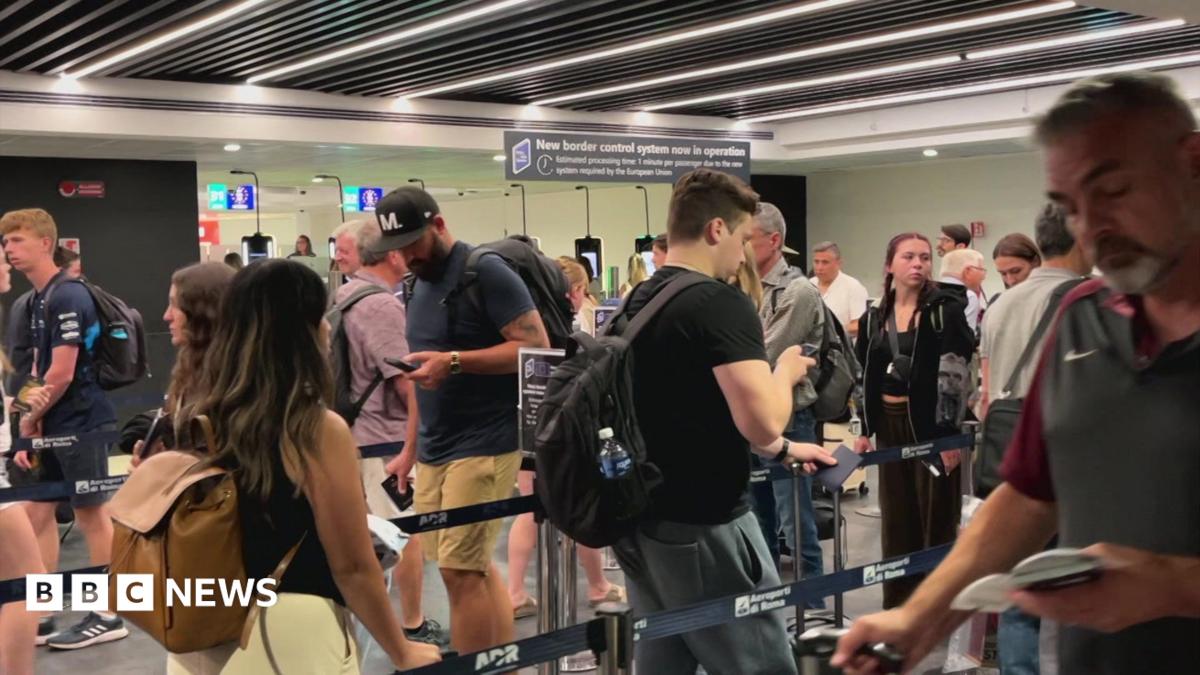 People move through the queue for the Entry Exit System process at Fuimicino Airport in Rome, Italy.