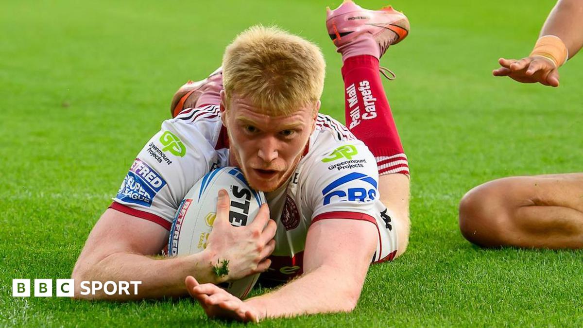Wigan Warriors wing Zach Eckersley dives over the line for the first of his three tries.