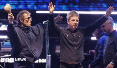 Liam Gallagher and Noel Gallagher of Oasis receive the applause of fans while on stage together at the Rose Bowl Stadium in Pasadena, California in September 2025