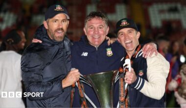 Ryan Reynolds, Phil Parkinson and Rob Mac pose with the National League trophy
