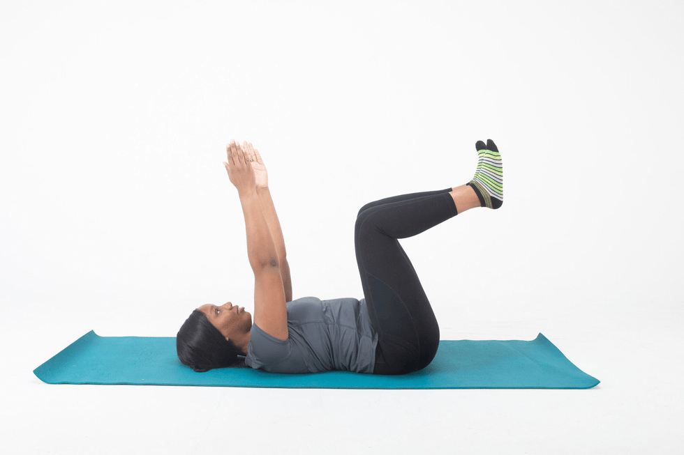 Person performing an exercise on a yoga mat person performing an exercise on a yoga mat