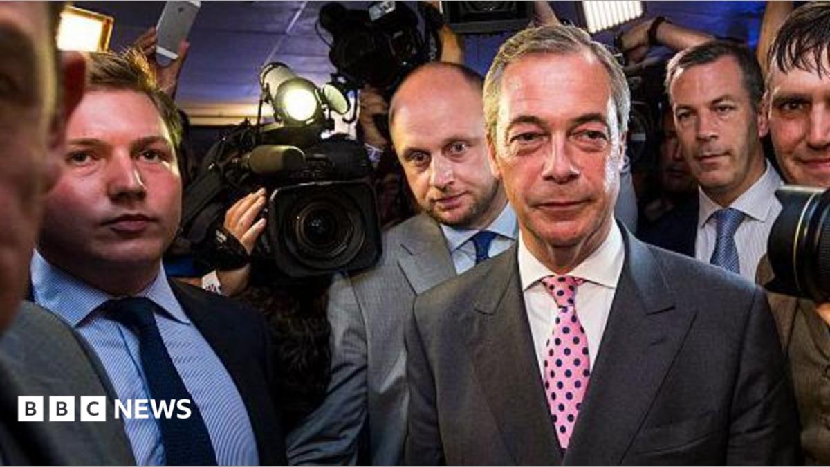 Nigel Farage arrives at the Leave.EU campaign's referendum party in 2016. To his far-right is George Cottrell wearing a light blue shirt and navy tie.