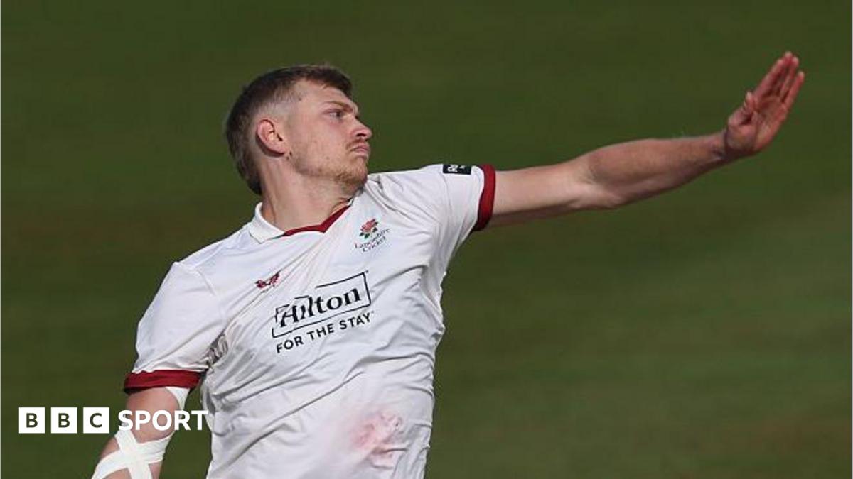 A side-on shot of Mitch Stanley bowling for Lancashire in the Championship