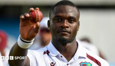 West Indies fast bowler Jayden Seales holds up the ball to celebrate taking five wickets against Pakistan