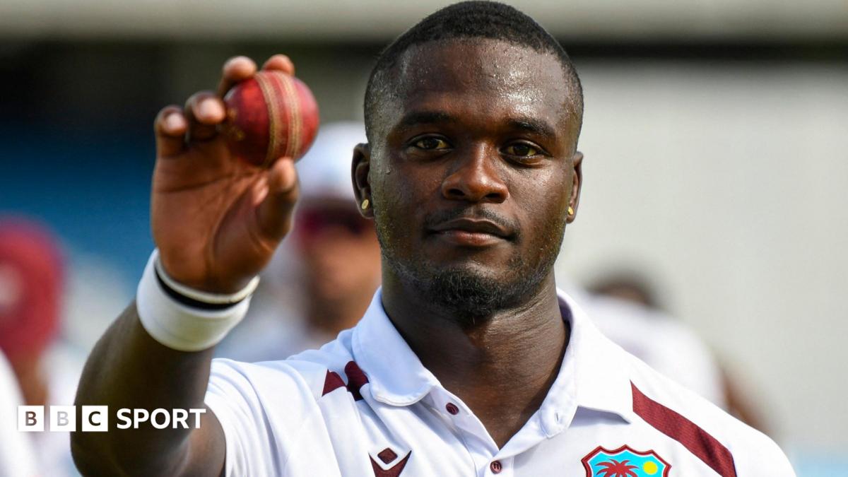 West Indies fast bowler Jayden Seales holds up the ball to celebrate taking five wickets against Pakistan