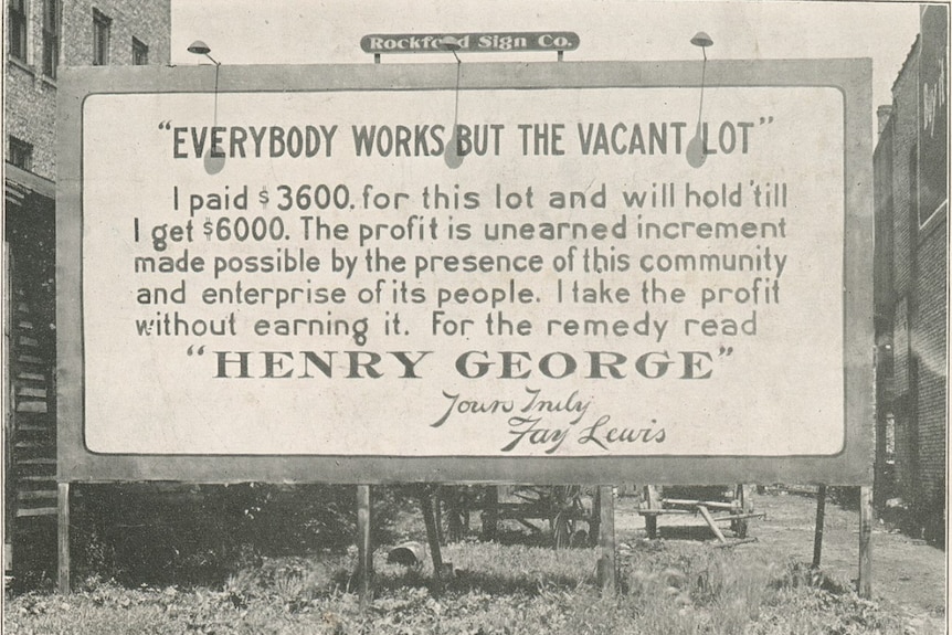 A billboard on an empty lot.
